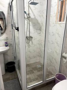 a shower with a glass door in a bathroom at Beautiful 2Br Apt in Ogba, Ikeja, Lagos in Lagos