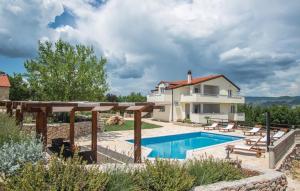 a villa with a swimming pool and a house at Villa Iva Grubine - near Makarska (Split County) in Grubine