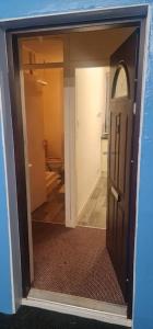 a view of a room with a door and a hallway at Modern flat in Jerviston Court in Motherwell