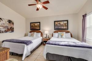 a bedroom with two beds and a ceiling fan at Steps to the Beach and Restaurants! - Coconut Villa's Suite 1 in St. Pete Beach