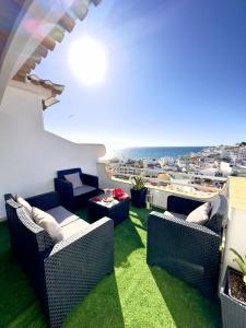 a balcony with couches and a view of the ocean at Duplex Sea View by Albufeira Holidays in Albufeira