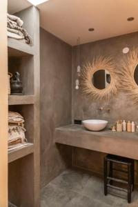 a bathroom with a sink and two mirrors at HAERT Boutique Wellness Suites City Centre in Haarlem