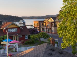 a town with houses and a boat in the water at The Web Suites in Friday Harbor