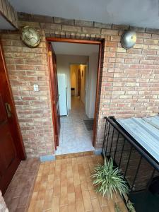 a brick wall with a hallway leading to a door at Apartamento Nuevo Centro in Córdoba