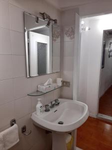 a white bathroom with a sink and a mirror at Il Nido in Sestri Levante