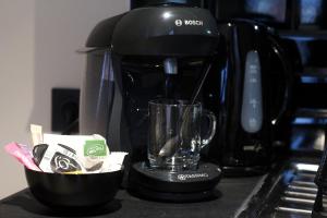 a coffee maker sitting on top of a counter at Résidence "Le Vélodrome" in Maubeuge +6 photos
