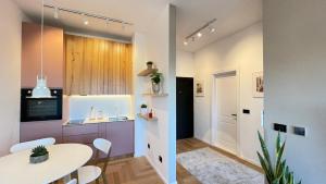 a kitchen and dining room with a table and chairs at Floral Inn in Pristina