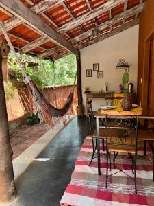 a patio with a hammock in a house at Chalés na Roça in Pirenópolis