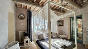 a bedroom with a canopy bed in a room at Podere Le Vedute in Larciano