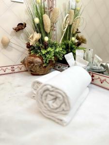 a pile of towels on a table with plants at Duplex Sea View by Albufeira Holidays in Albufeira