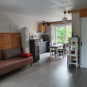 a living room with a couch and a kitchen with a table at Jeju Damda in Jeju +28 photos