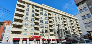 a large building with a sign in front of it at Floral Inn in Pristina
