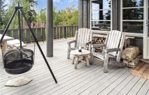 a porch with two chairs and a fire place at 4 Bedroom Pet Friendly Home In Eggedal in Eggedal