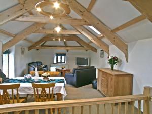 a living room with a table and chairs and a ceiling at Proper Job in Tresmeer