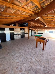 a large room with a ping pong table in it at Águas Rasas - Flats in Arraial do Cabo