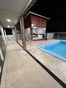 a swimming pool in the middle of a house at Águas Rasas - Flats in Arraial do Cabo