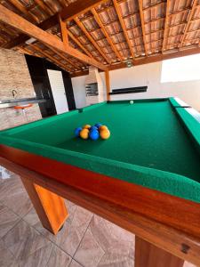 a pool table with balls on top of it at Águas Rasas - Flats in Arraial do Cabo