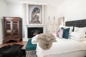 a bedroom with a large bed with a fireplace at 70 On Mortimer in Mudgee