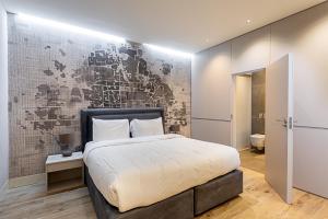 a bedroom with a large bed and a wall at Mews house in London