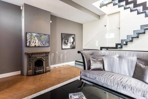 a living room with a couch and a fireplace at Mews house in London