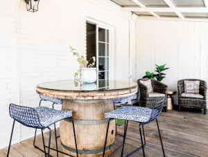 a patio with a table and chairs on a porch at 70 On Mortimer in Mudgee
