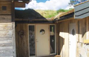 a house with a grass roof with a door at Holiday Home Dølemo Hillestadheia Ii in Øvre Ramse +26 photos