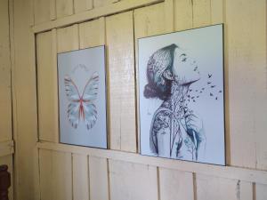 three drawings of a girl and butterflies on a wall at Fazenda São Matheus in Lauro Müller