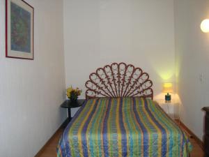 a bedroom with a bed with a colorful bedspread at Apartment Face Aux Pistes in Gréolières les Neiges