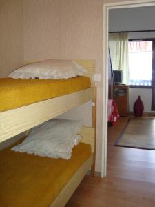 a bedroom with two bunk beds and a living room at Apartment Face Aux Pistes in Gréolières les Neiges