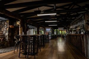 a row of bar stools in a wine tasting room at Tullah Lakeside Lodge in Tullah +78 photos