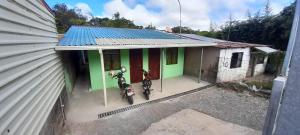 two motorcycles parked outside of a small house at La casa de tia in Monteverde Costa Rica