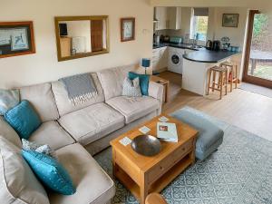 a living room with a couch and a table at Sunrise in Coughton