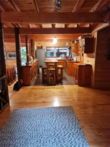 a large kitchen with wooden floors and a table and chairs at HuiloHuilo San Avellano en Reserva Biologica in Huilo Huilo