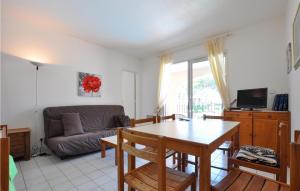 a living room with a table and a couch at Amazing Apartment In Sainte-Maxime in Sainte-Maxime