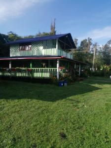 a large house with a yard in front of it at CABAÑA ENCANTO in Saboyá