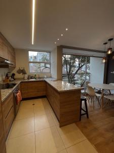 a kitchen with a large counter and a table at Modern Apartment in the Heart of Quito in Quito