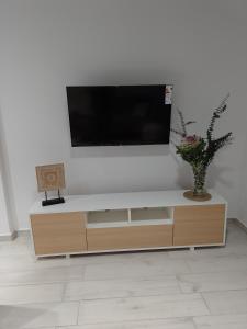 ein Wohnzimmer mit einem TV an einer weißen Wand in der Unterkunft Magnolias in Ranelagh