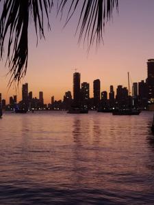 a view of the city from the water at sunset at Cartagena Apartamento en Manga de 2 Habitaciones in Cartagena de Indias