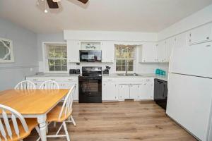 a kitchen with a table and a white refrigerator at Close to All Springfield Attractions!! in Springfield