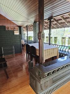 an old stove in a room with a table and chairs at The Four Seasons in Kalpetta