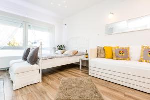 a living room with two white couches and a window at Apartment Cologne in Cologne