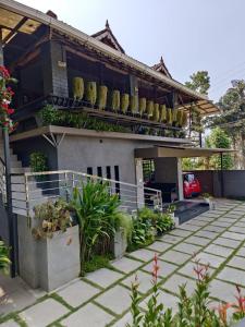 a house with plants on the front of it at The Four Seasons in Kalpetta