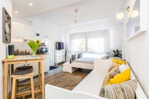 a living room with a white couch and a kitchen at Apartment Cologne in Cologne