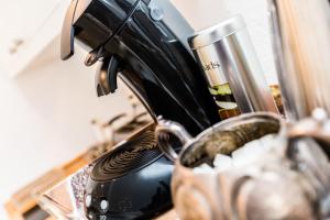 a coffee maker sitting on a counter next to a cup at Apartment Cologne in Cologne