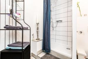a bathroom with a shower and a bath tub at Apartment Cologne in Cologne +19 photos