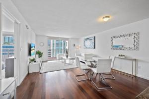 a dining room and living room with a table and chairs at Superb unit, centrally located with parking in Miami