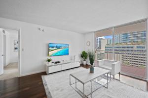 a living room with a tv and a table at Superb unit, centrally located with parking in Miami