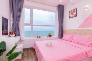 a bedroom with a pink bed and a large window at John Wick 2 Apartment in Vung Tau in Vung Tau +69 photos
