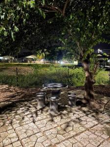 a picnic table under a tree in a park at DakNan Homestay Duyong in Malacca