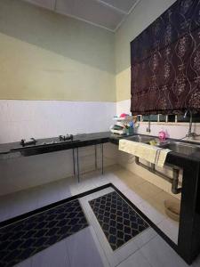a kitchen with a sink and a counter top at DakNan Homestay Duyong in Malacca